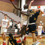 Jeffrey Anyimah drives past Mariner’s Jailin Johnson (on the ground) and Jalen Giles (on the right)