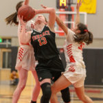Cameron Dunn being fouled by Sammamish’s Sarah Skaggs on the way to the hoop