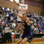 Mason Christianson making a layup over Anacortes’ Alek Miller