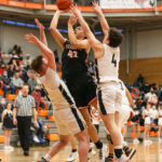 Don Brown going for a layup over Arlington’s Luke Brown (left) and Grayson Falk (right)