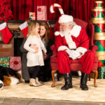 Santa brings a smile to a young child’s face