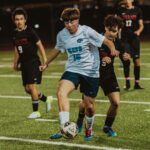 Meadowdale sophmore Caleb Waddel runs ahead of Terrace Opponents.