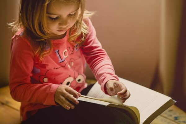 A child pages through a library book.