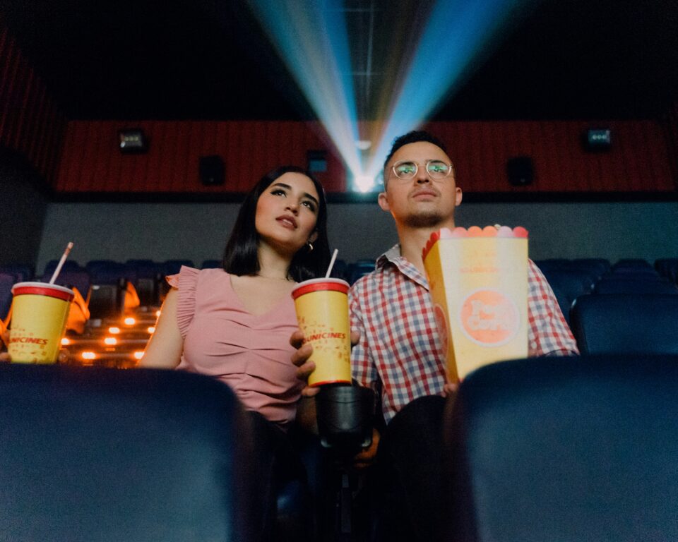 A couple on a kid-free date at a movie theater. 
