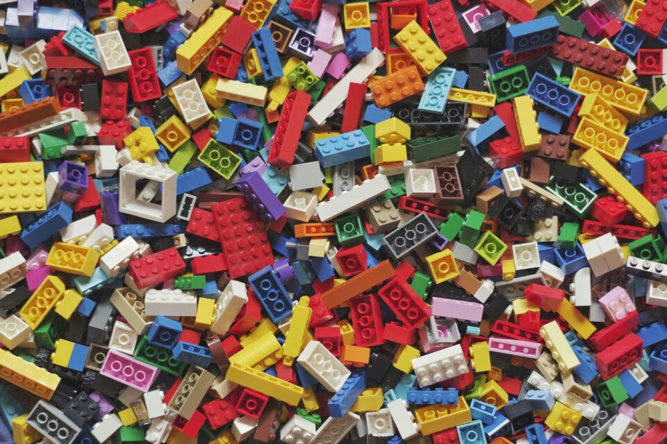 A pile of colorful LEGO bricks is shown.