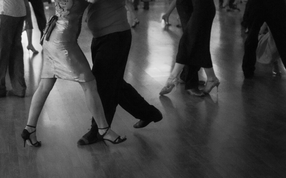The feet of people social dancing are shown in an action shot. 
