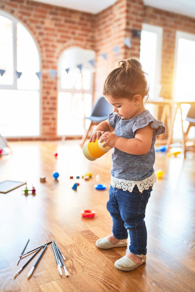 A child plays with toys in an indoor space. 